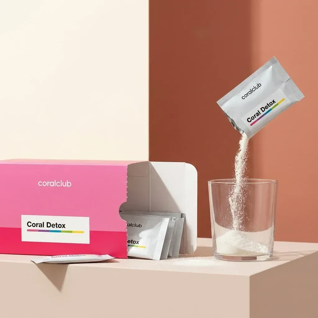 Coral Detox powder being poured into a glass from a pink and white box.
