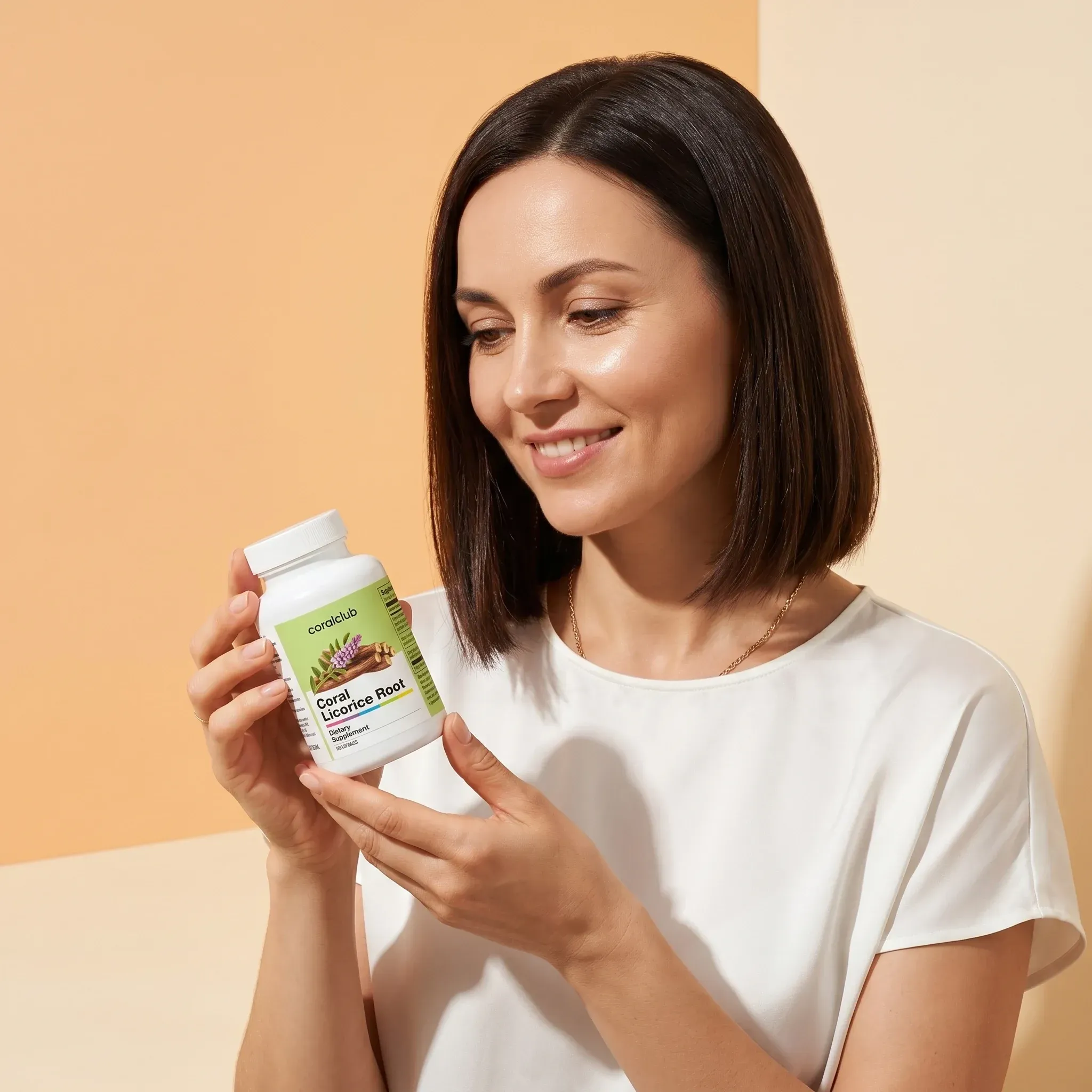 Woman holding Coral Licorice Root supplement bottle in a lifestyle setting.