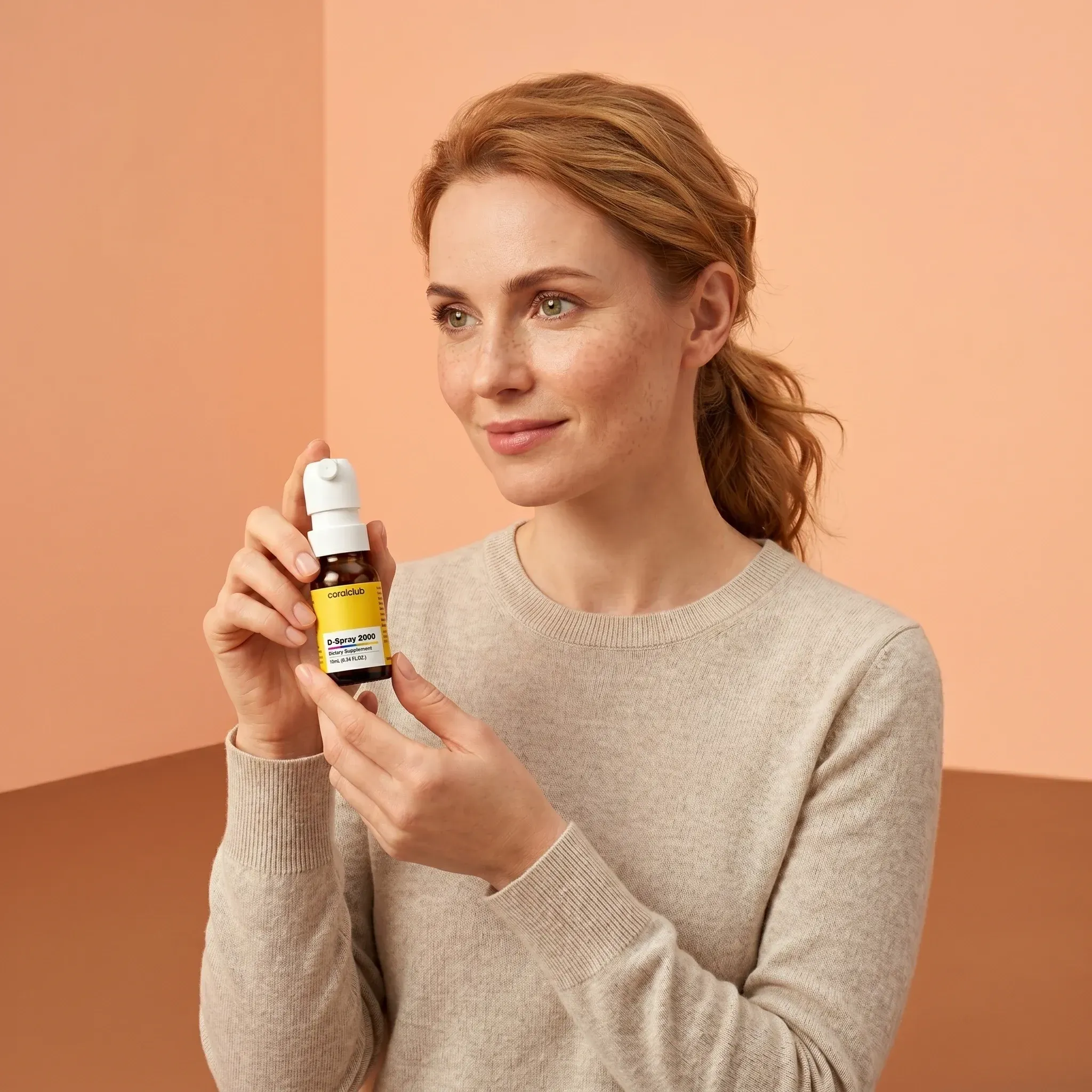 D-Spray 2000 lifestyle image of a woman holding the product in a softly colored room.