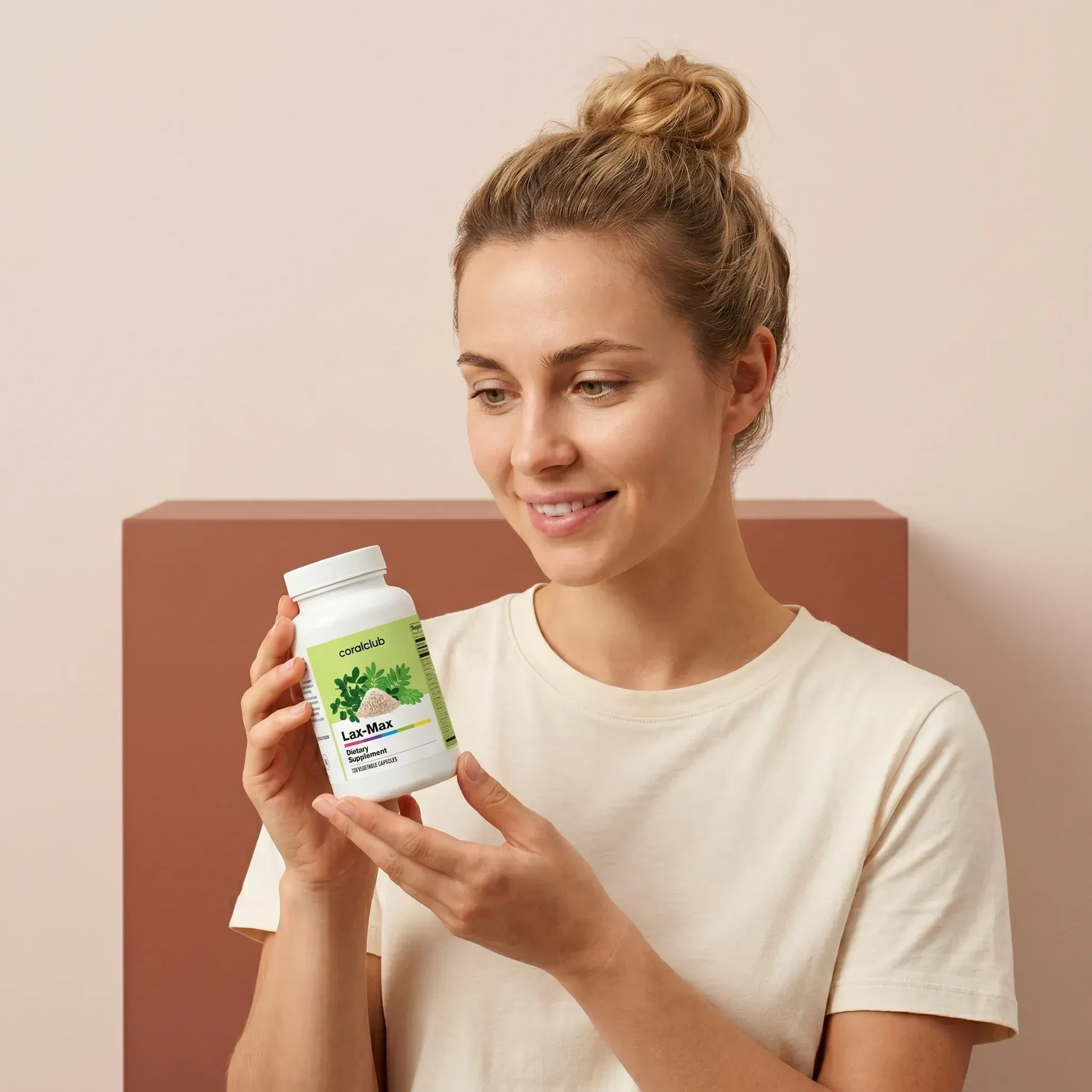 Lax-Max lifestyle shot with a woman holding the supplement bottle against a soft pastel background.