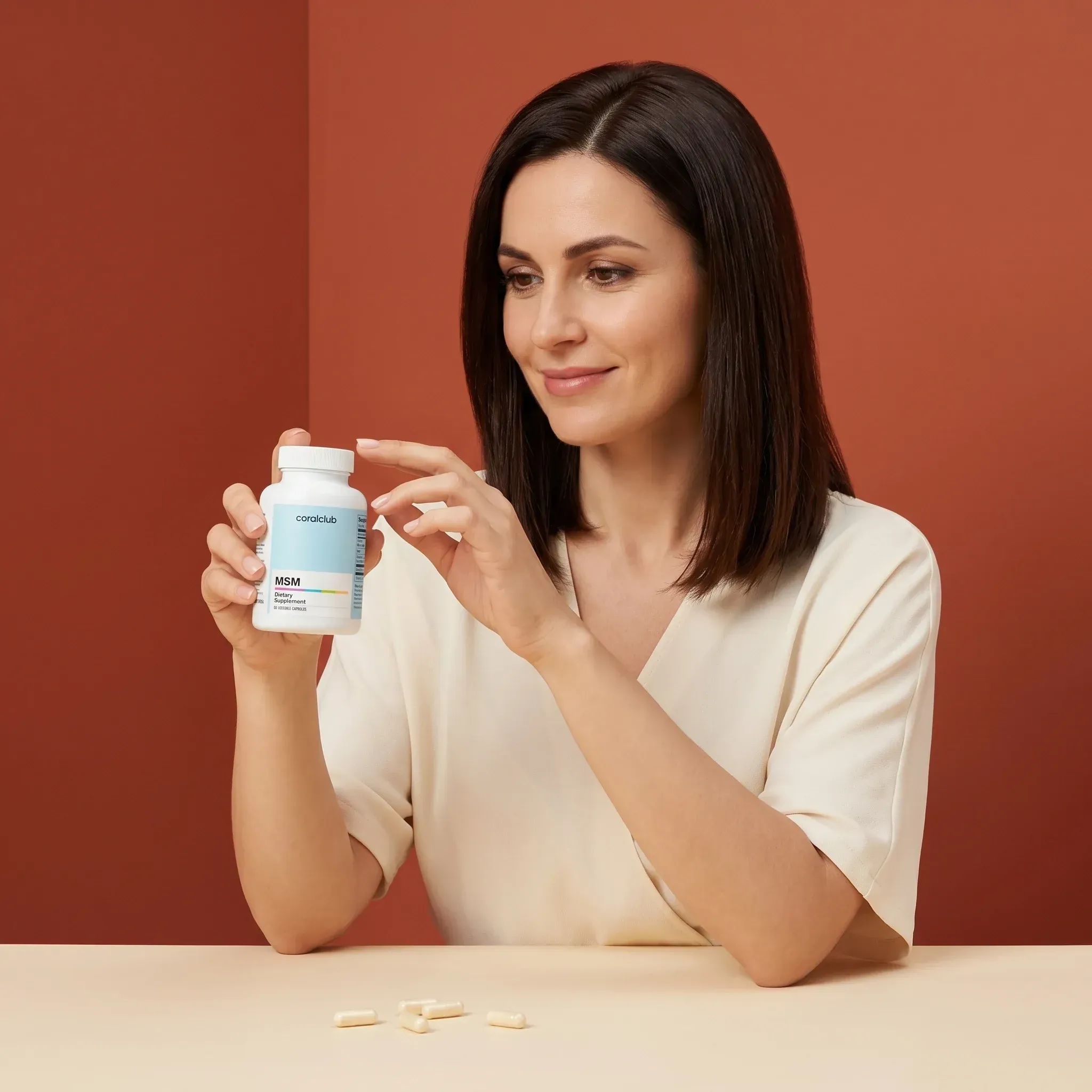 Woman examining a bottle of MSM supplements in a lifestyle setting with soft, warm tones.
