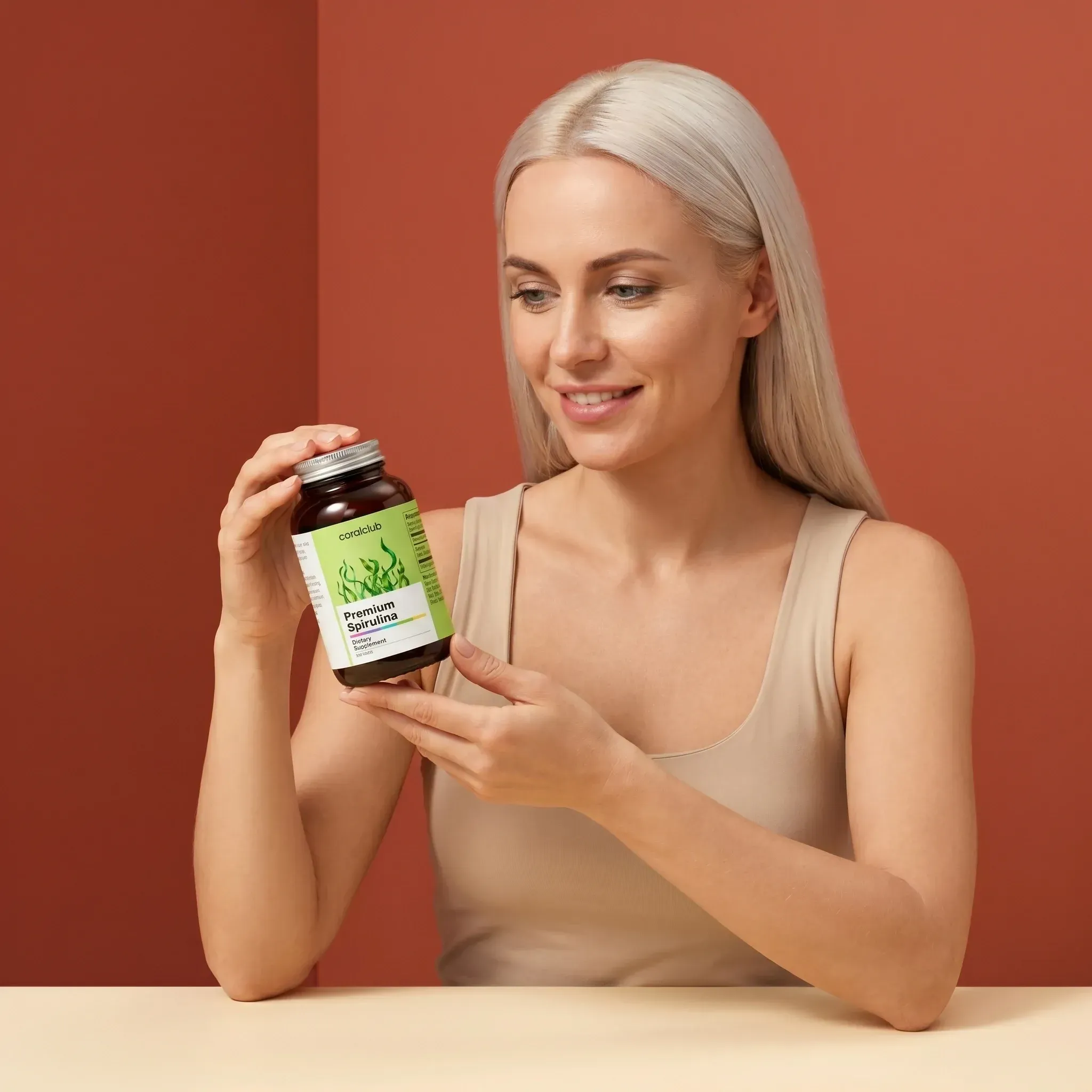 Woman holding Premium Spirulina supplement bottle against a warm background.